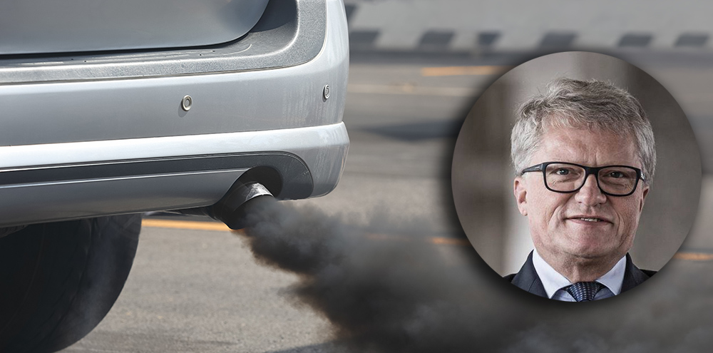 Air pollution from vehicle exhaust pipe on road.
