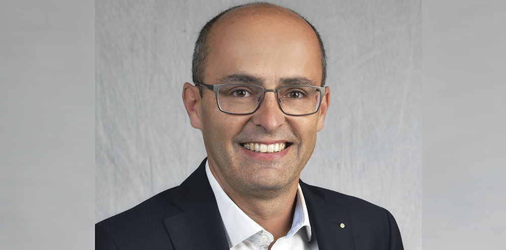 Cheerful couple holding vote icon sitting on a couch