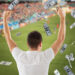 online betting, gambling and sport concept - happy man with raised hands and money rain over football field background
